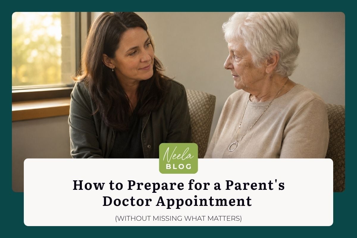 Adult daughter sits beside her elderly mother in a softly lit waiting room, preparing for her parent's doctor appointment together.