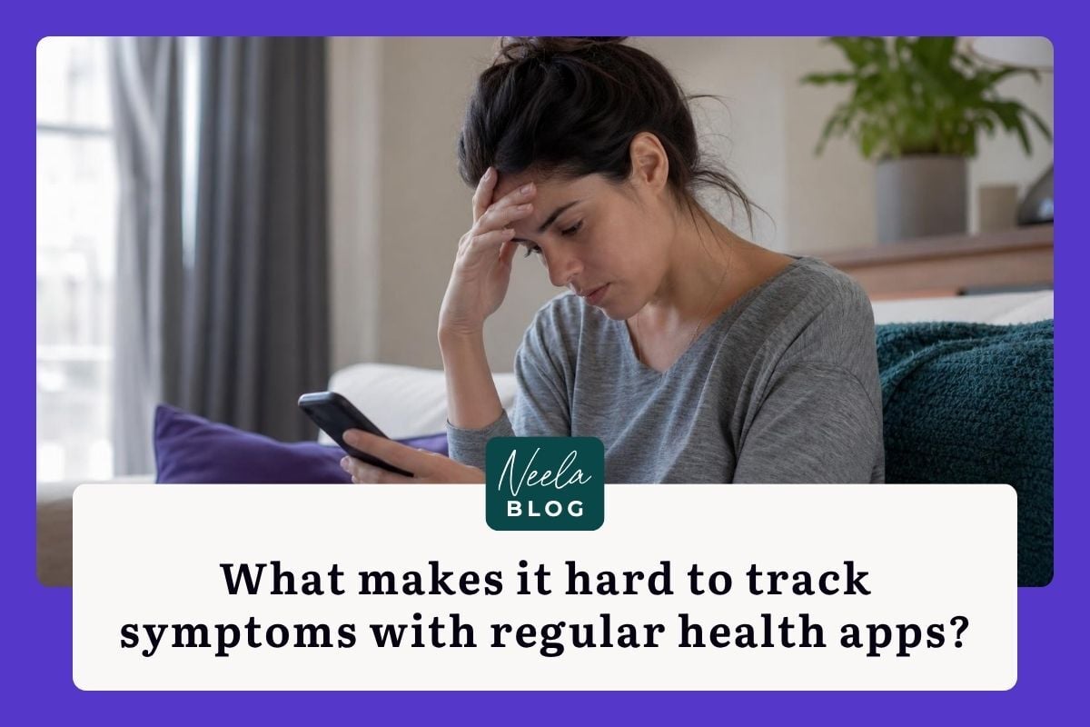 Frustrated woman sitting on a couch holding her forehead while looking down at a smartphone in a dimly lit living room.